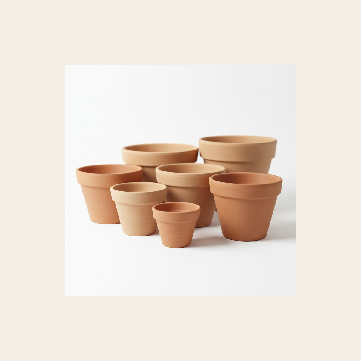 Group of terracotta pots and saucers.